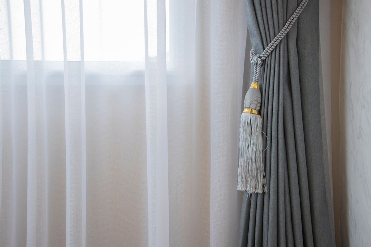 A decorative tasselled tieback holding a curtain